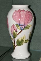A LARGE MOORCROFT POTTERY VASE, of shouldered form, tube lined in Magnolia pattern on a cream