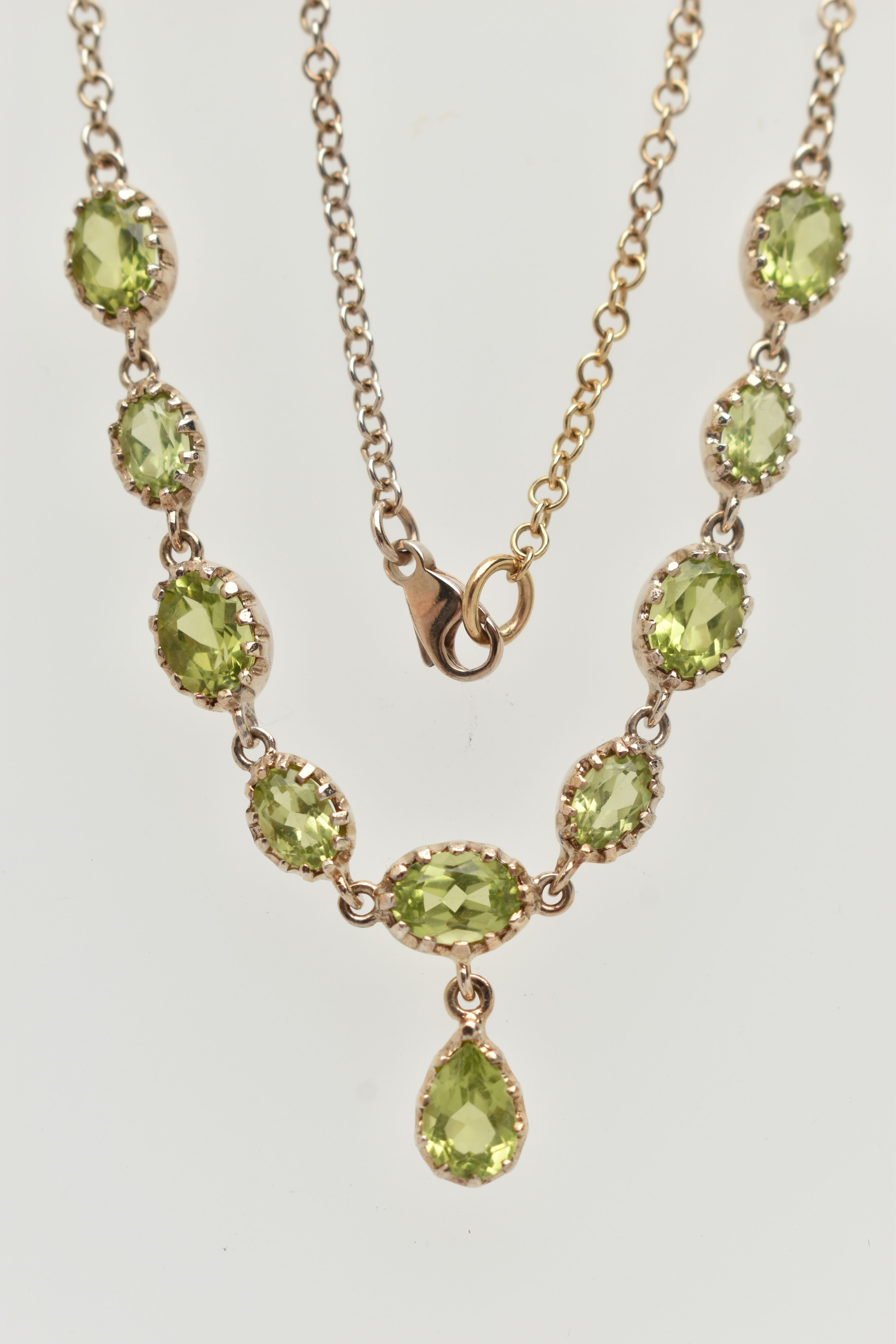 A YELLOW METAL PERIDOT NECKLACE, designed as a row of nine oval cut peridots, each in a claw - Image 2 of 4