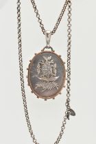 A LATE 19TH CENTURY SILVER LOCKET, a large oval locket with raised floral and foliage detail, a