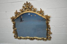 A GILT RESIN OVERMANTEL MIRROR, the foliate frame depicting flower heads and scrolls, width 122cm