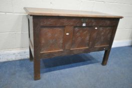 AN OAK COFFER, incorporating a various age of timbers, with a hinged lid enclosing a candle box, the
