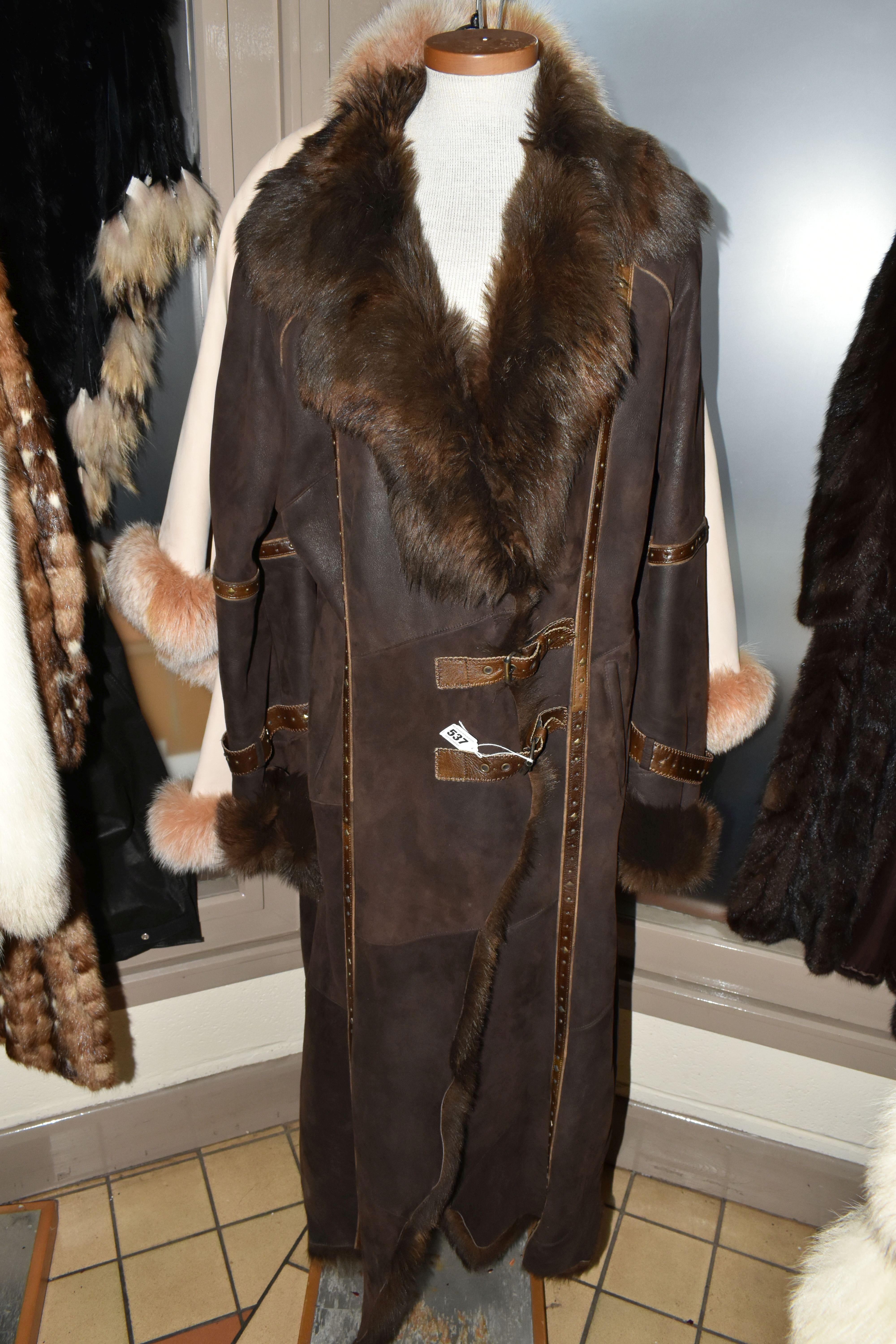 A SUEDE CAPE WITH FUR COLLAR AND BROWN LEATHER LADIES SHEEPSKIN, comprising an apricot coloured