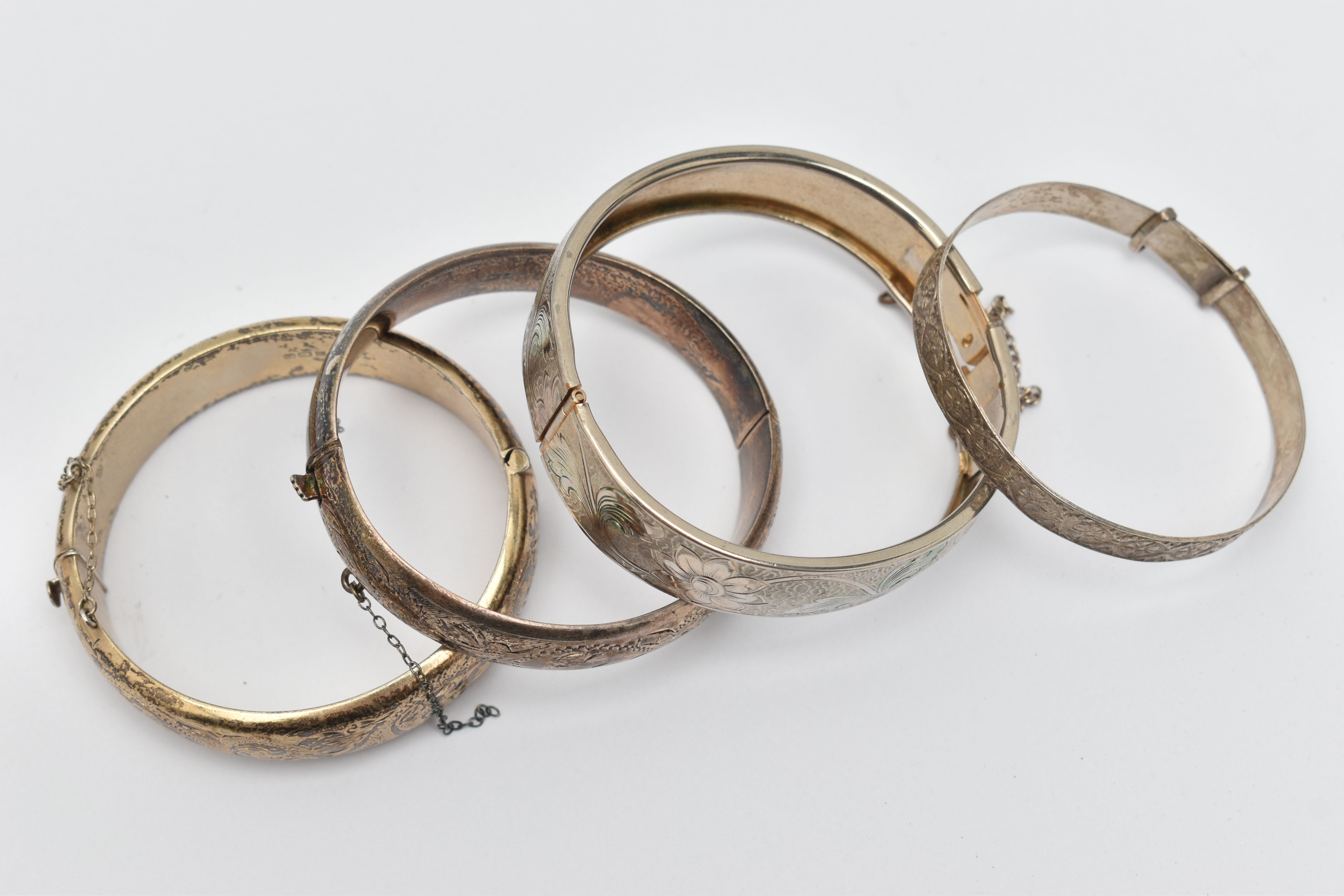 FOUR BANGLES, to include two silver foliage pattern hinged bangles, both fitted with push button - Image 2 of 3