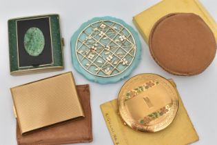 FOUR COMPACTS, to include a boxed 'Kigu' compact, a floral detailed 'Kigu' compact with pouch, a