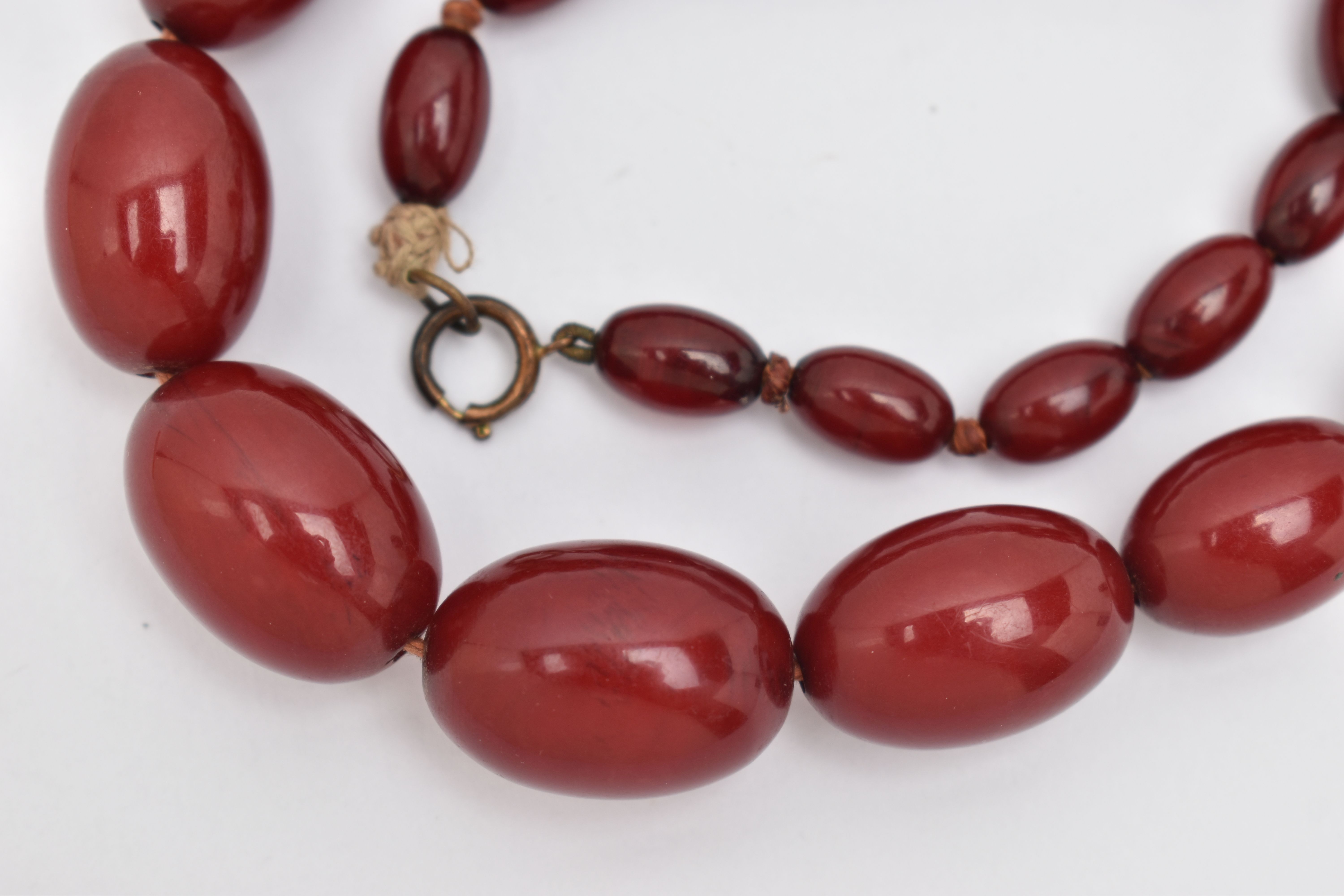 A BAKELITE BEADED NECKLACE, graduated oval cherry amber beads, twenty seven beads in total, - Image 2 of 4