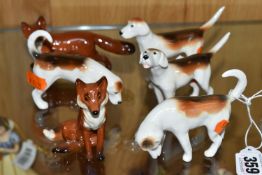 A GROUP OF BESWICK FOXES AND FOXHOUNDS, comprising Foxhounds model nos 941, 942, 943 and 944, and
