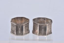 A PAIR OF LATE VICTORIAN SILVER OCTAGONAL NAPKIN RINGS, alternate engine turned and engraved panels,