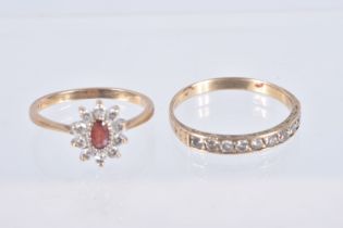 TWO YELLOW METAL GEM SET RINGS, the first an oval cluster set with an oval cut garnet and colourless