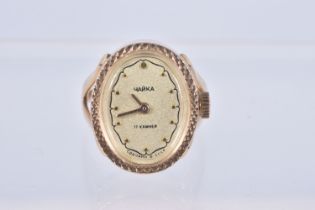 A RUSSIAN YELLOW METAL WATCH RING, hand wound movement, oval dial signed 'Yanka', dot markers,