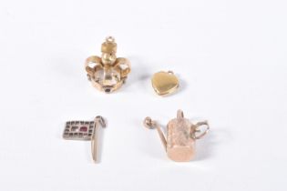 FOUR MAINLY VICTORIAN CHARMS, to include a diamond and ruby set flag, set with a central square