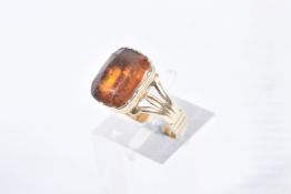 A MID VICTORIAN PASTE RING, the rectangular orange paste in a closed back setting, to the