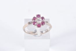 A YELLOW METAL, DIAMOND AND RUBY CLUSTER RING, flower cluster set with a central round brilliant cut