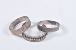 TWO SILVER HINGED BANGLES AND A WHITE METAL CUFF BRACELET, the first a flat hinged bangle with