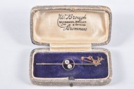 A YELLOW METAL DIAMOND BAR BROOCH, polished bar with open work centre piece set with two old cut