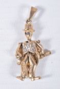 A 9CT GOLD ARTICULATED MAN PENDANT, gentlemen holding a bottle with top hat on, set with blue