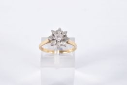 A DIAMOND CLUSTER RING, the central brilliant cut diamond in a star setting within a tiered single