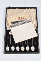 CUNARD INTEREST, A CASED SET OF TWELVE SILVER AND ENAMEL COFFEE SPOONS AND A SIGNED CUNARD QUEEN