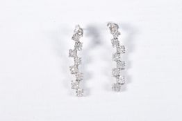 A PAIR OF 9CT WHITE GOLD DIAMOND DROP EARRINGS, each earring set with a row of illusion set round