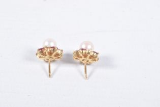 A PAIR OF YELLOW METAL CULTURED PEARL AND GEM SET EARRINGS, each set with a single cultured pearl,