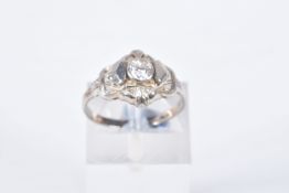 A SINGLE STONE DIAMOND RING, designed as a central old cut diamond within a pierced geometric
