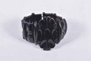 A CARVED JET STRETCH LINK BRACELET, large carved oval centre and carved links, all fitted onto a