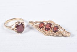 A 9CT GOLD RING AND YELLOW METAL BROOCH, an oval cut garnet, prong set in yellow gold leading on