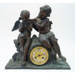A French bronze figural mantel clock, with two cherubs seated above the circular dial, with enamel