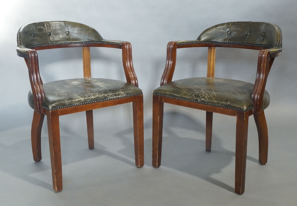 A pair of mahogany desk chairs, 20th century, with stud bound green leather upholstery, raised on