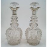 A pair of cut glass decanters and stoppers with silver collars, Sheffield, 1924, probably Walker &