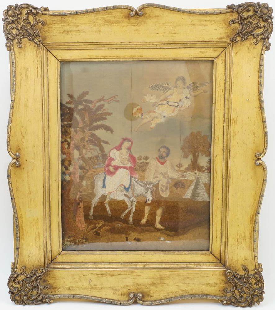 Two framed silk embroidered pictures, 19th century, one depicting The Flight into Egypt, with Joseph