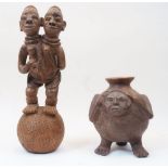 A terracotta figure with two heads stood atop a ball, approx. 48.5cm high; together with an