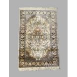 A small Persian part silk Kashan rug, 20th century, central floral medallion on a cream ground,