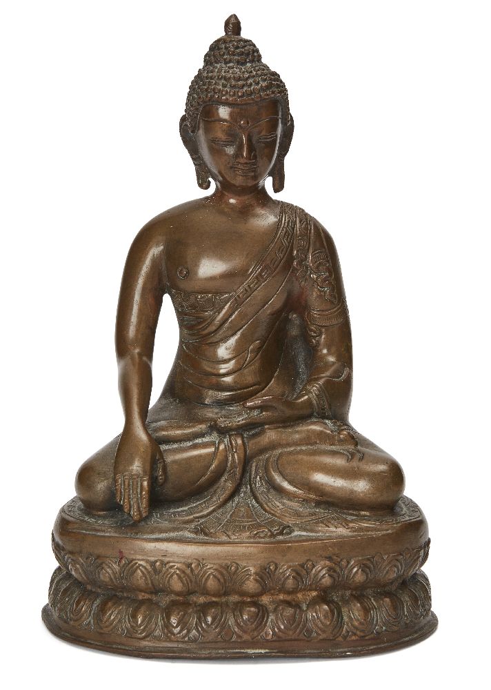 A Nepalese bronze Buddha, 18th century, cast sitting on a waisted lotus base in Bhumisparsha