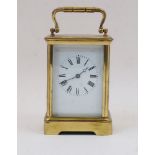 A French gilt-brass carriage clock, early 20th century, the corniche case with swing handle and