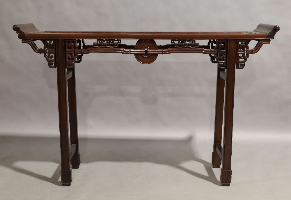 A Chinese hardwood altar table, 20th century, carved and pierced frieze, raised on block supports to