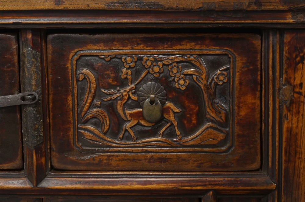 A Chinese elm side cabinet, early 20th century, the rectangular top above two drawers, carved with - Image 4 of 4