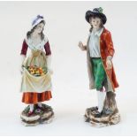 A pair of German porcelain figures, late 19th / early 20th century, depicting a farmer and a fruit