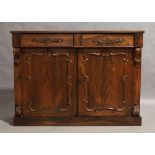 A Victorian rosewood side cabinet, circa 1880, two drawers over two cupboard doors, with carved