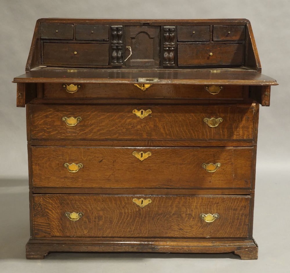 A George III oak bureau, circa 1780, the hinged fall front enclosing fitted interior, above dummy - Image 2 of 2