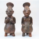A pair of terracotta figural vessels, Nigeria, 20th century, depicting women with headdresses,