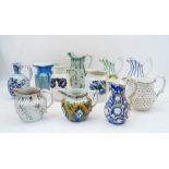 A group of eleven pottery jugs, late 19th-20th century, including: a Wemyss jug with flowers; a