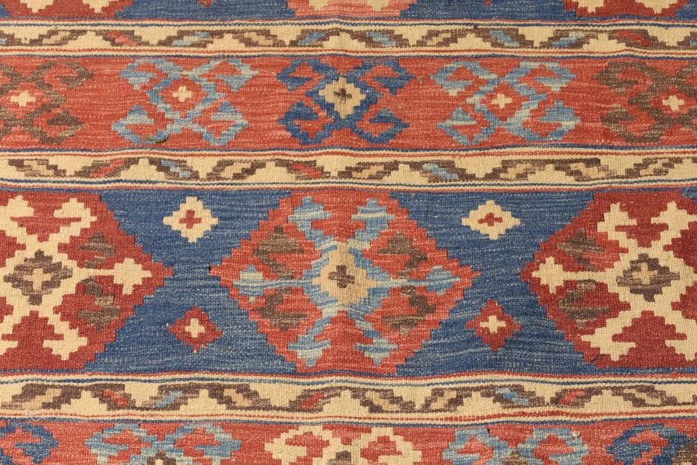 A Persian kilim carpet, late 20th century, geometric designs on a blue and red ground, 276cm x 188cm - Image 2 of 3