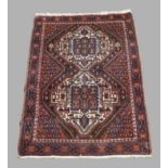 A Persian Afshar rug, 20th century, double diamond medallion with geometric design, on a cream and