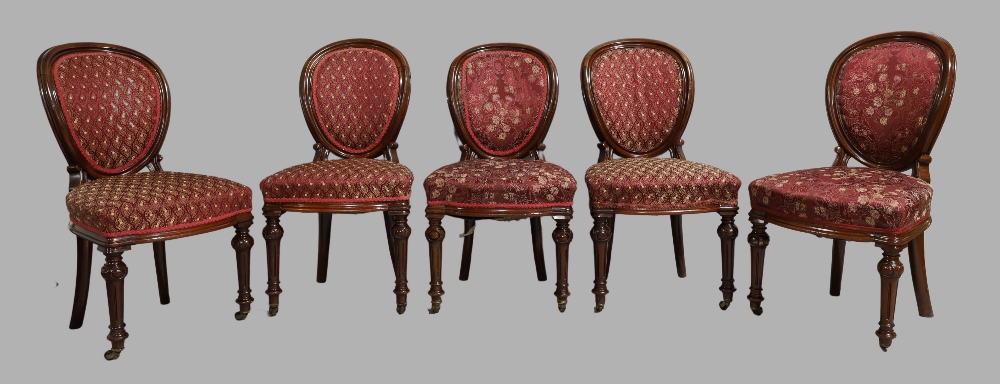 A set of five Victorian mahogany dining chairs, circa 1880, spoon shape backrests, red floral