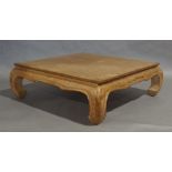 A Chinese style teak low table, square top raised on curved supports, 42cm high, 130cm wide, 130cm