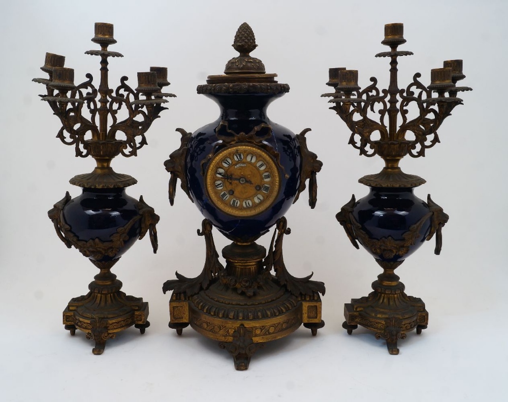 A French gilt-bronze mounted porcelain clock garniture, late 19th century, the case and garniture