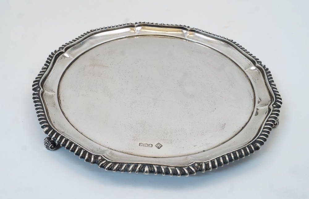 A silver salver, Sheffield, 1924, William Lister & Sons, with scalloped and gadrooned rim on three