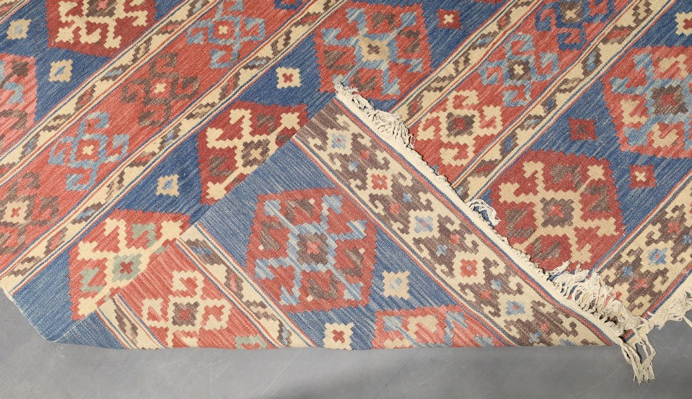 A Persian kilim carpet, late 20th century, geometric designs on a blue and red ground, 276cm x 188cm - Image 3 of 3