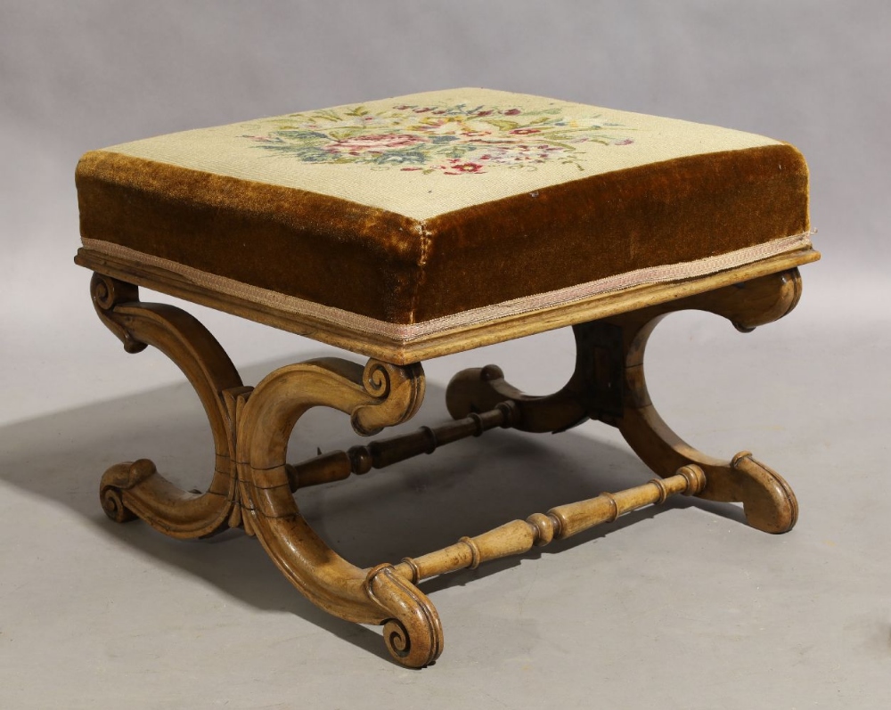 A Victorian mahogany X-framed stool, circa 1860, with floral needlework seat, 42cm high, 56cm