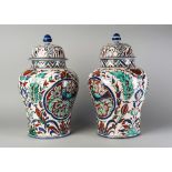 A pair of European pottery baluster jars and covers, in the Iznik style, 20th century, 42cm high (